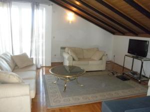 a living room with a couch and a coffee table at Apartment Preka in Rab