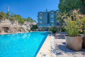 a swimming pool in front of a building at AEGEAN Apartments - Çeşme in Cesme