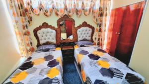 two beds sitting next to each other in a bedroom at Affordable Hyswan Family Guesthouse in Krugersdorp