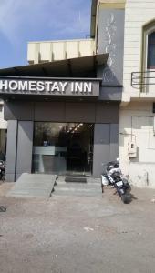 a motorcycle parked in front of a home stay inn at Homestayinn in Ahmedabad