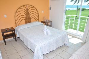 En eller flere senge i et værelse på Hotel Boca de Ovejas