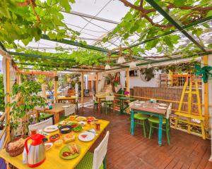 a restaurant with tables and chairs and a lot of plants at DuruPduru Kaş in Kas