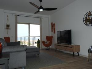 a living room with a couch and a flat screen tv at THE VIEWS, LAS VISTAS in Peñíscola