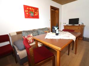 sala de estar con mesa de madera y silla en Apartment Heidi, en Vandans