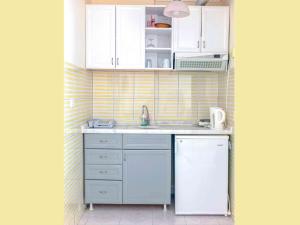 a small kitchen with a sink and a refrigerator at Victoria Princess Apart Hotel in Side