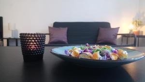 a plate of salad sitting on a table at Sziget Apartman in Eger