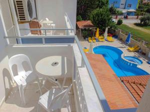 a balcony with a pool and a table and chairs at Victoria Princess Apart Hotel in Side