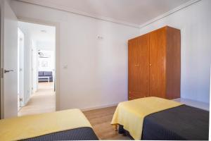 Łóżko lub łóżka w pokoju w obiekcie Apartamento Isbilya