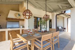 a dining room with a wooden table and chairs at Villa Leucolea with pool in Cres