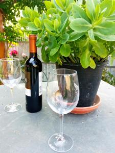 a bottle of wine and two wine glasses on a table at Azevinho Guest House in Seia