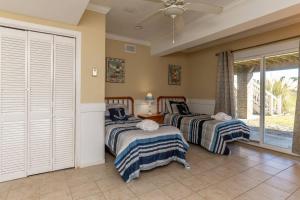 two beds in a room with a window at Fripp Island 422 Wahoo Drive in Fripp Island
