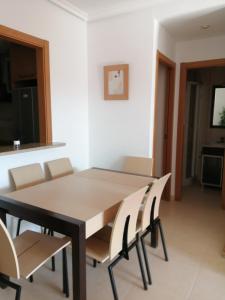 a dining room with a table and chairs at Magic World Aguamarina in Oropesa del Mar