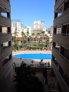 a view of a swimming pool between two buildings at Magic World Aguamarina in Oropesa del Mar