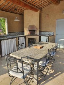 a large wooden table and chairs in a kitchen at Villa L'Estagniol in Lourmarin