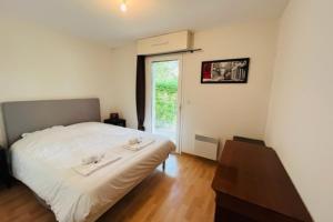 1 dormitorio con cama, mesa y ventana en 72m With Terrace And Garden Center Of Baden en Baden