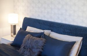 łóżko z niebieską deską z poduszkami w obiekcie Great Living w mieście Rodos