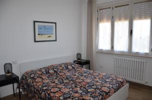 A bed or beds in a room at La Cicala del Conero