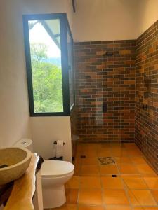 a bathroom with a toilet and a window at Reserva de Gomalu in San Francisco +24 photos