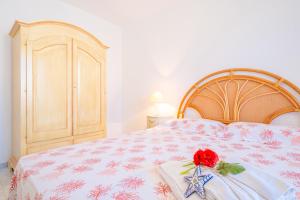 a bedroom with a bed with a red rose on it at Chiara & Giulia Apartments by HDSalento in Leuca