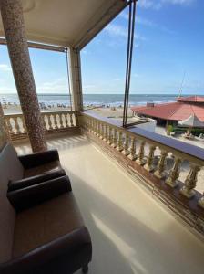a balcony with a couch and a view of the ocean at Villa Teba - Marouf Group in Ras El Bar