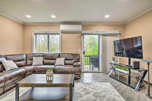 a living room with a leather couch and a flat screen tv at Great Gorge Getaway with Community Amenities! in Vernon Township
