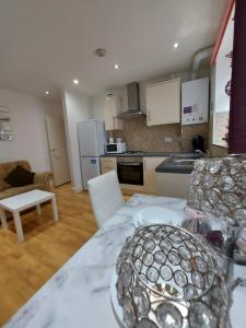 a kitchen with a table and a counter top at Lux Apartment in Gatwick in Crawley