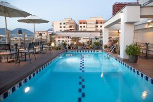 a swimming pool on the roof of a building at Mondial Hotel in Tirana