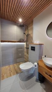 a bathroom with a toilet and a sink at Tuia Apartment in Pärnu