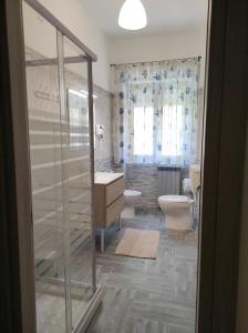 a bathroom with two toilets and a glass shower at Blue Marine di Ostia in Lido di Ostia