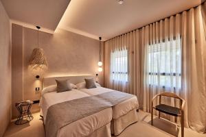 a bedroom with a large bed and a window at JOE'S GOMILA BOUTIQUE HOTEL in Palma de Mallorca