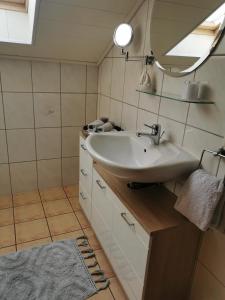 a bathroom with a sink and a mirror at Apartment Hasselstrasse in Mehren