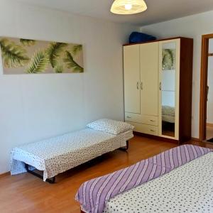 a room with two twin beds and a cabinet at Ana Apartments in Vis