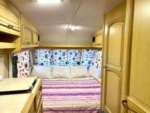 a small room with a couch in the back of a rv at Sunny House Caravans in Sozopol