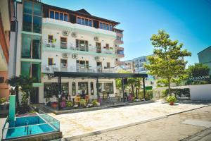 a building with a pool in front of it at Sangiovanni in Shëngjin