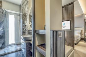a bathroom with a sink and a mirror at Hotel Albatros Varigotti in Varigotti +37 photos