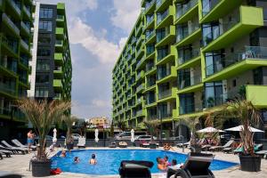 a swimming pool in front of two tall buildings at CRYSTAL ApartHotel & Spa Mamaia Nord in Mamaia Sat/Năvodari