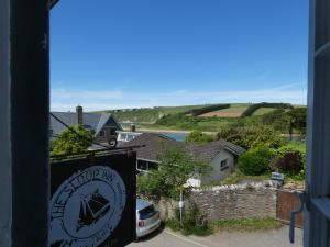 a sign for a mountain inn with a view of a house at The Sloop Inn in Kingsbridge
