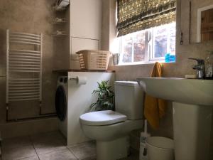 a bathroom with a toilet and a sink at Primrose Cottage - Tideswell, Peak District in Tideswell +23 photos