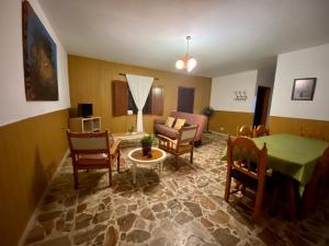 a living room with a couch and a table and chairs at Vv. Casa La Fuente II in Isora