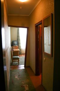 a hallway with a door leading to a room with a desk at Don Kihot Hotel in Novovolynsʼk