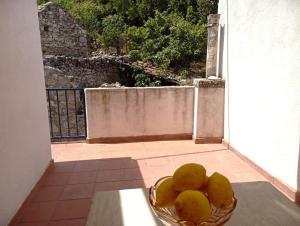 a bowl of fruit on a table on a balcony at Ana Apartments in Vis