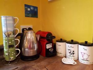 a group of coffee pots sitting on top of a counter at Room with a view in Killarney