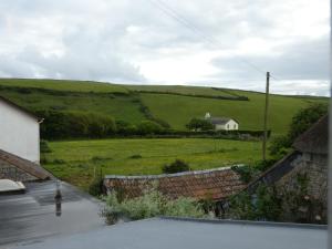 a view of a field with a house in the distance at The Sloop Inn in Kingsbridge