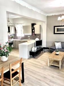 a living room with a table and a kitchen at NICOL APARTMENS in Preveza