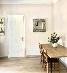 a dining room with a table and chairs and a mirror at NICOL APARTMENS in Preveza