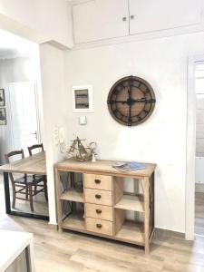 a room with a desk and a clock on the wall at NICOL APARTMENS in Preveza