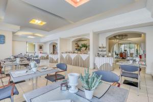 a living room filled with furniture and tables at Hotel Albatros Varigotti in Varigotti