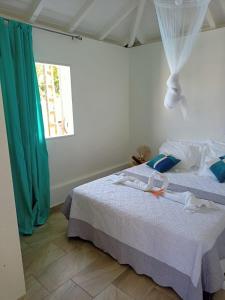 a bedroom with two beds with towels on them at O'Parad'îles in Goyave +32 photos