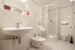 een badkamer met een wastafel, een toilet en een douche bij Tolstov Apartments - 1 , 2 and 3 Room Monteur Apartments in Duisburg +37 foto's