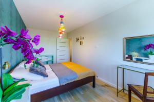 a bedroom with a bed and a table at SUN 7 - osiedle JANTAR in Kołobrzeg